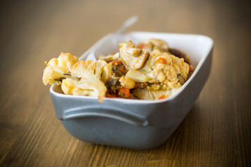 Cauliflower baked with mushrooms and eggplants in ceramic form
