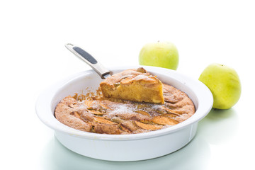 sweet apple pie in ceramic form on white