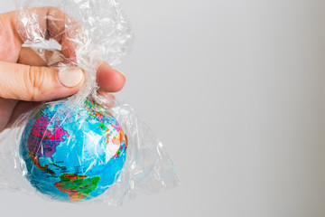 small globe of Earth in a plastic bag. The concept of the pure Earth