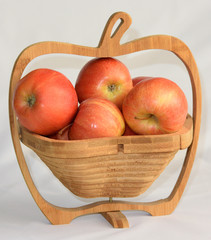 Wooden vase in the shape of an apple with apples