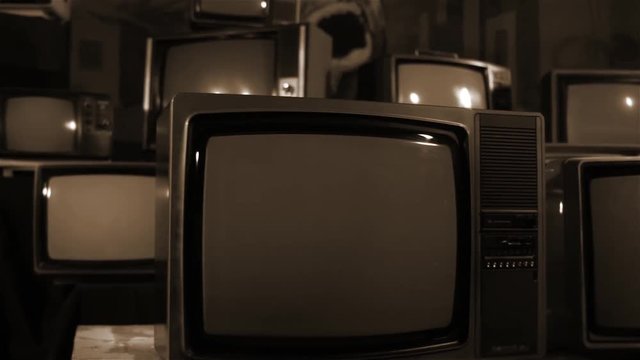 Old TVs Turning On Green Screen, with Many Old Tvs. Sepia Tone. You can replace green screen with the footage or picture you want with “Keying” effect (check out tutorials on YouTube). 