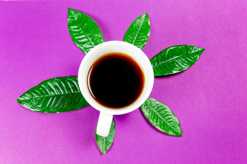coffee is a fuel concept - a cup on a purple background