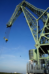 Fototapeta premium Industrial crane against blue sky