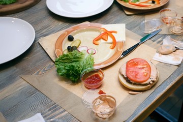 fresh vegetables, hamburger bun and utensils for cooking classes on wooden table, concept of cooking class