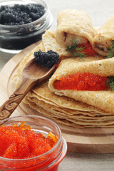 Russian pancakes with red and black caviar
