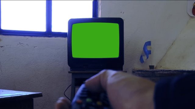 Male Hand Turning On Tv With Green Screen. You can replace green screen with the footage or picture you want with “Keying” effect in After Effects  (check out tutorials on YouTube). 