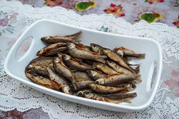 Home made food fried fish on large ceramic bowl