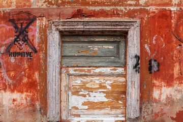 Wooden dyed boards. Wall with peeling paint of a old abandoned house. Background 