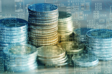 Double exposure of stack of coins and graphics card with graph for business finance concept