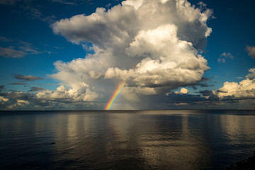 Rainbow of clouds in the northern latitudes in the summer before the rain