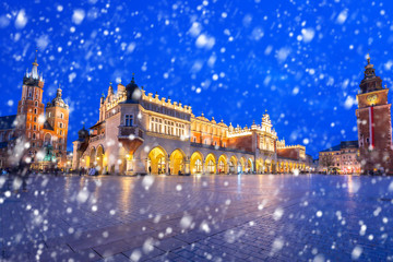 Old town of Krakow on a cold winter night with falling snow, Poland