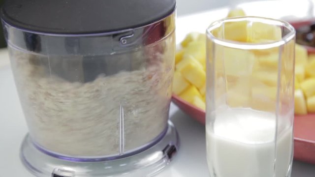 woman chopping nuts in a blender for cooking healthy food