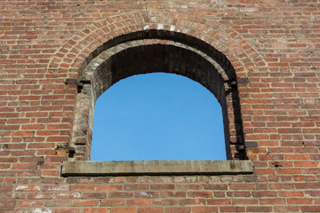 blues sky through a window in brick wall