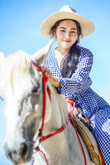 Beautiful woman riding a white horse at the beach