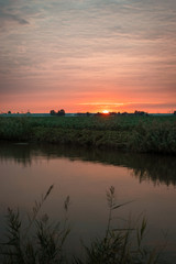 Rustic and colorful sunset over the dutch countryside. Photographed on an autumn day, in the area between Gouda and Leiden, Holland. October 15th 2018.