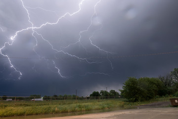 Naklejka na ściany i meble Active lightning show over northeast Nebraska at midnight. Photographed in the town of Norfolk, Nebraska in southeasterly direction. June 1st 2018.
