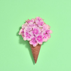 Bouquet of Flowers in Ice Cream Cone. Trendy fashion Style. Spring Summer Floral concept. Creative Minimal. Pink Blossom on green, Art