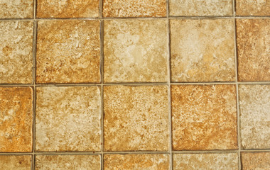 Naklejka premium Abstract brown tone marble stone block tiles pattern background in natural concept Decorative modern rough block texture background arrangement in asymmetry seamless wall of interior building design