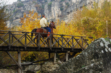 Safranbolu, Kastamonu / Turkey - November 15 - 2015 : Horse trainer man riding the horse on bridge