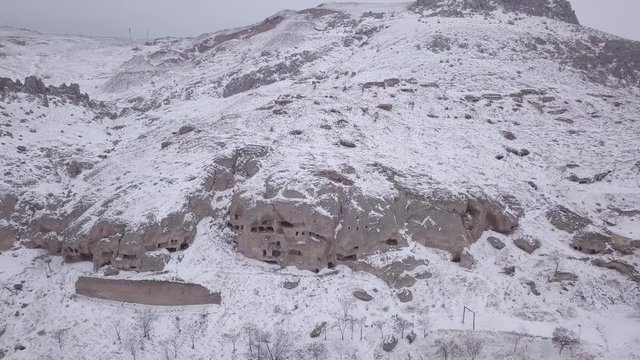 flying to ancient caves on a snowy hill