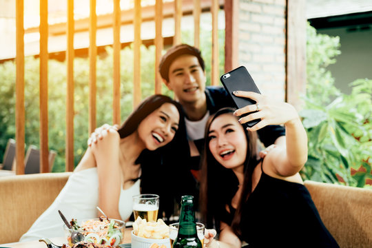 Teenage brides are having fun in the party and using mobile phone talking selfie photo.