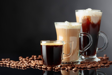 Various coffee drinks on a black background.