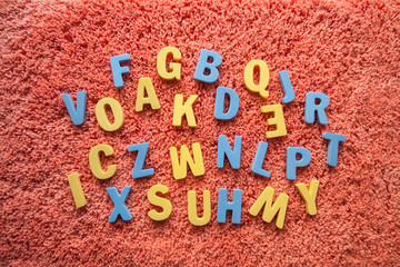 the letters of the alphabet in disorder on a pink background © Карина Желнина