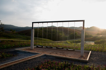 sunset and swings in flora park  Wang Nam Kiew, thailand