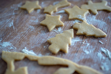 Christmas cookies preparation. Cookies cutter, dough for cookies and rolling pin on the kitchen...