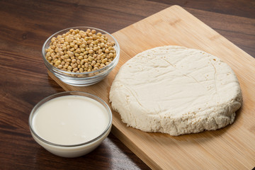Food : Bowls of Soy Milk,Soybeans And Tofu Isolated on Wooden Background