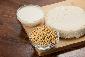 Food : Bowls of Soy Milk,Soybeans And Tofu Isolated on Wooden Background