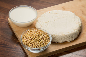 Food : Bowls of Soy Milk,Soybeans And Tofu Isolated on Wooden Background