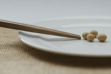 soy bean with chopsticks on plate