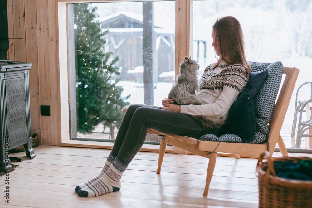 Wall mural Girl relaxing with cat at home