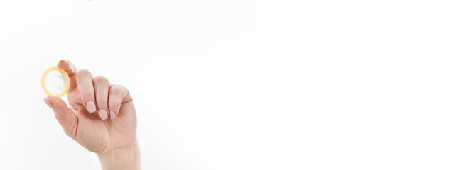 Woman holding Condom in hand,  safe sex concept.