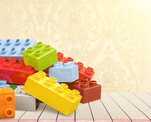 Colorful children building bricks on background