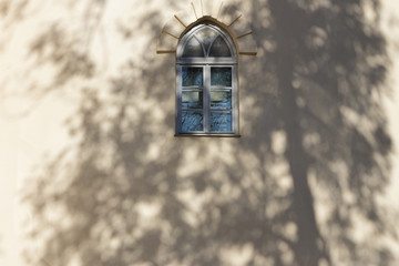 An ancient castle window with a shadow.
