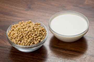 Food : Bowls of Soy  Milk  And  Soybeans Isolated on Wooden Background