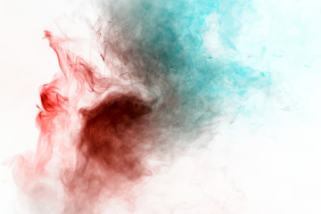 Multicolored curling smoke, red blue vapor, curled into abstract shapes and patterns on a white background, repeating the movement of waves and a chemical.