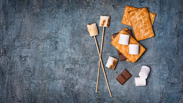 Top view on roasted marshmallow, crackers and chocolate as ingredients for s'mores