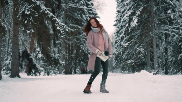 happy woman jumps up in twinter park