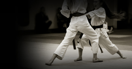 Children's training on karate-do. Banner with space for text. For web pages or advertising printing. Photo without faces, from the back. © Uladzimir