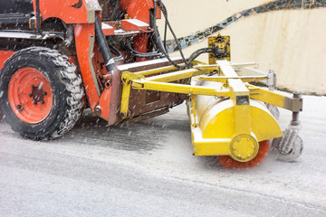 Snowblower cleans the road from snow