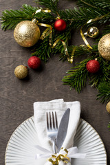 Christmas table setting with fork and knife and christmas decorations on plate