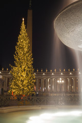 The Bernini's Fountain in front of the big Christmas Tree in Saint Peter Square, near the Basilica of Saint Peter in Rome, Italy