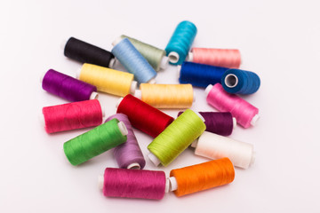 Spools with color threads. Threads of all colors isolated on White background.