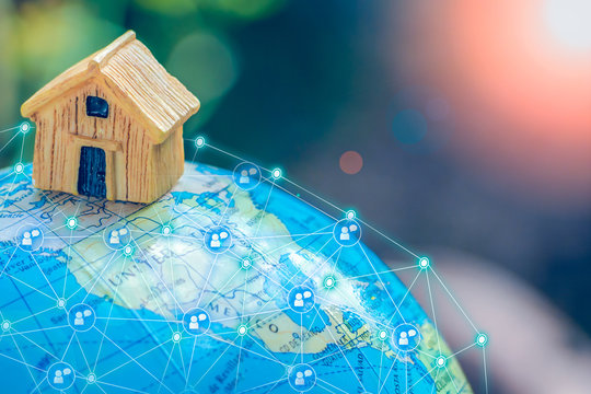 House or Home model with communication on globe model. Concept for loan, property ladder, financial, mortgage, real estate investment, taxes and bonus. Communication and network concept.