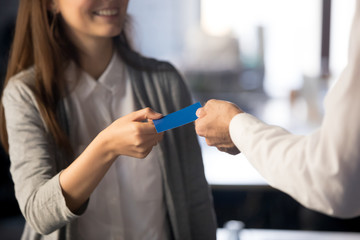 Businessman handing giving visiting business card for businesswoman client customer sharing offering personal information, introduction, exchanging contacts and networking concept, close up view