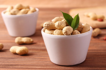 raw peanuts in shell on a wooden background.