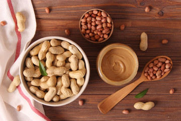  peanut butter and peanut beans on wooden background